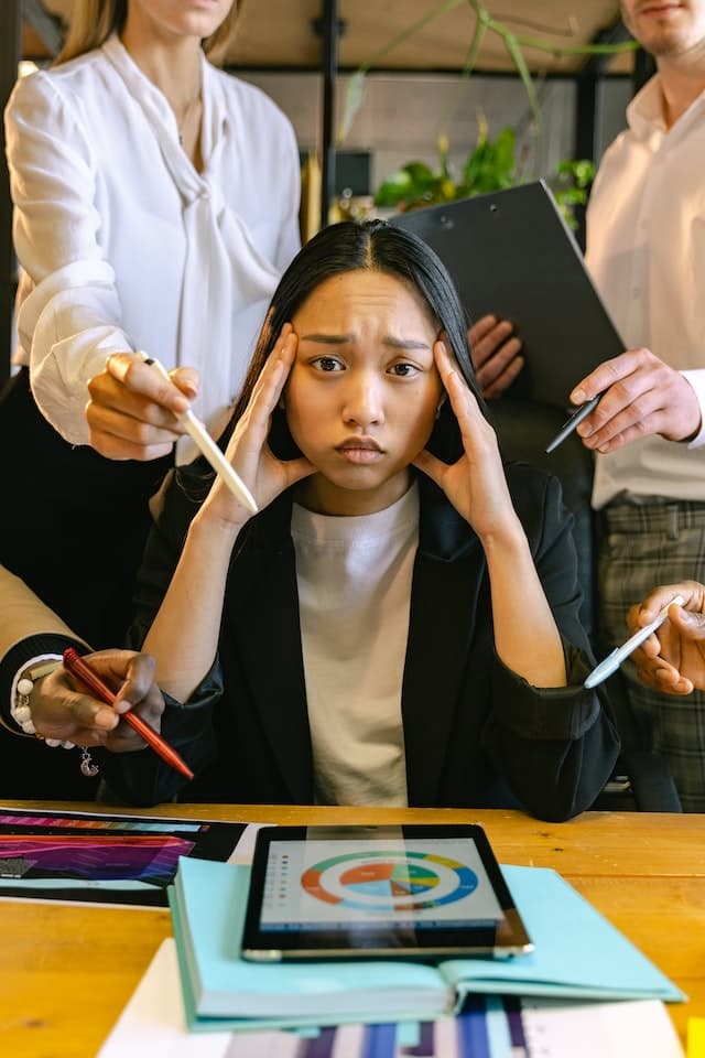 Overwhelmed professional surrounded by competing workplace demands